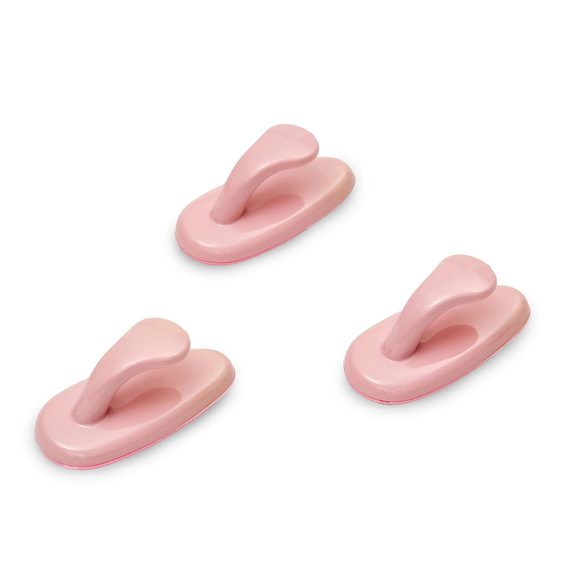 Multiple pink silicone sex toys on a white background.