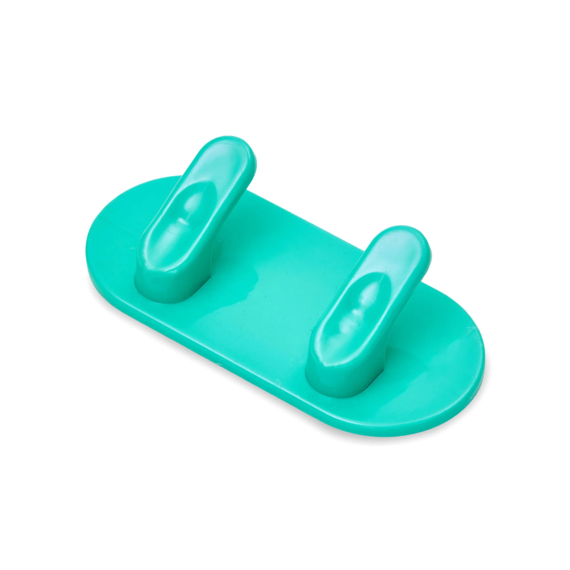 Close-up of a teal-colored plastic object with rounded, protruding shapes.