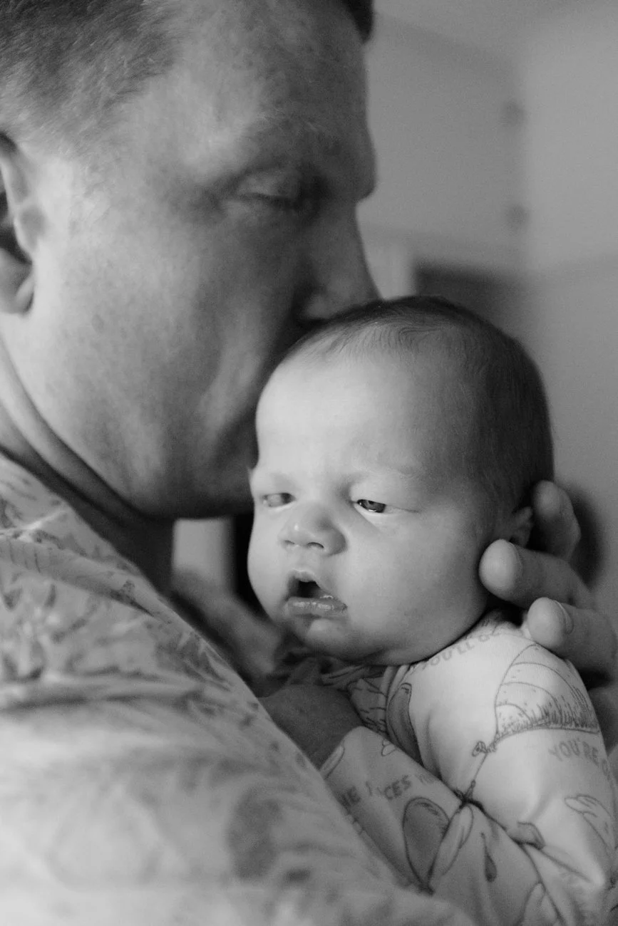 family-portraiture-father-cuddling-newborn.001.jpg