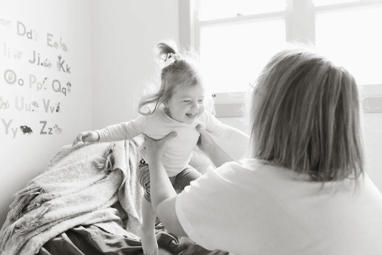 family-portraiture-child-jumping-to-mother.001.jpg