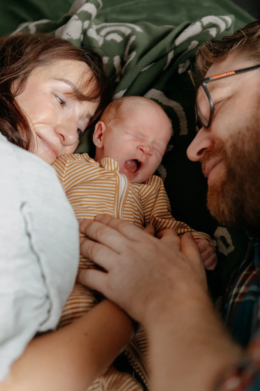 family-portraiture-father-mother-newborn-on-bed.001.jpg