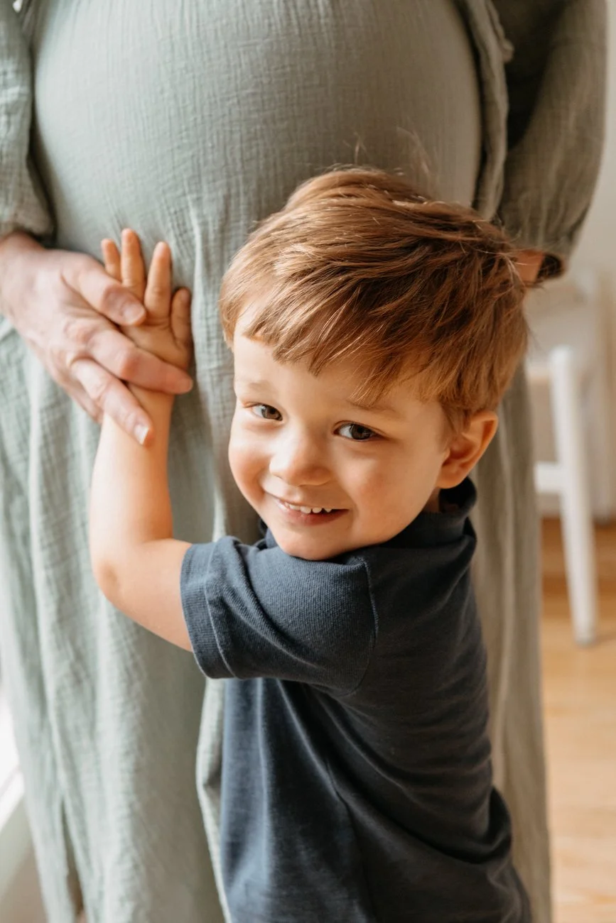family-portraiture-child-touching-pregnant-belly.001.jpg