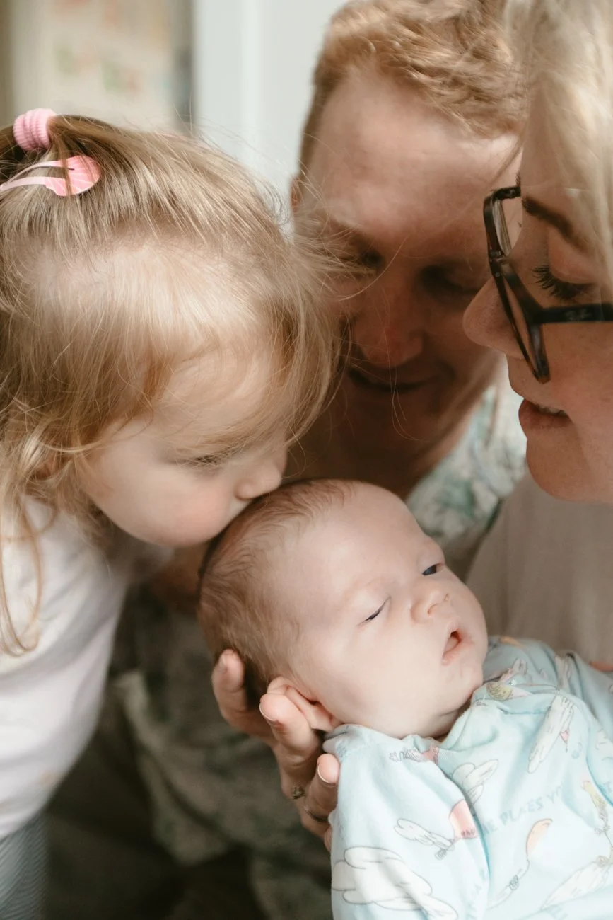 family-portraiture-childs-kissing-newborn.001.jpg