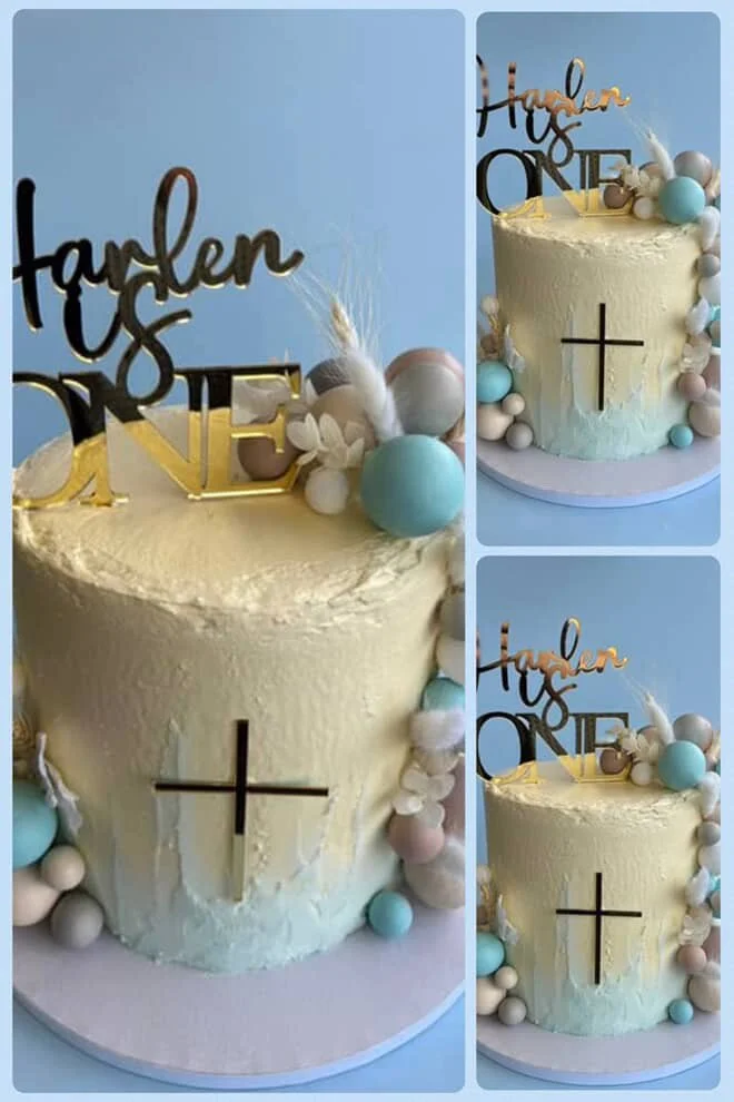 Three images of a birthday cake with a religious cross and gold lettering that reads 'Haden's ONE'. The cake is decorated with pastel-colored spherical and floral decorations and is set against a light blue background.