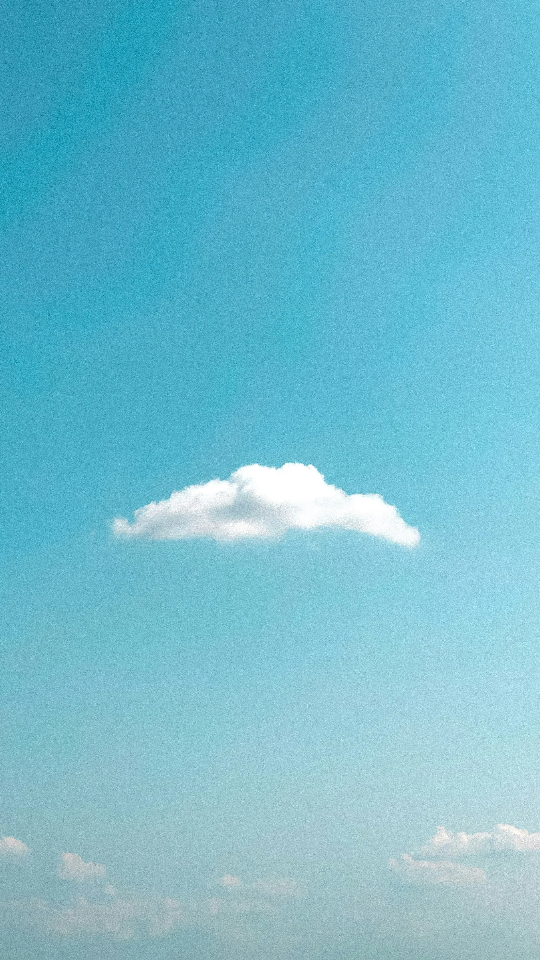 A clear blue sky with scattered white clouds.
