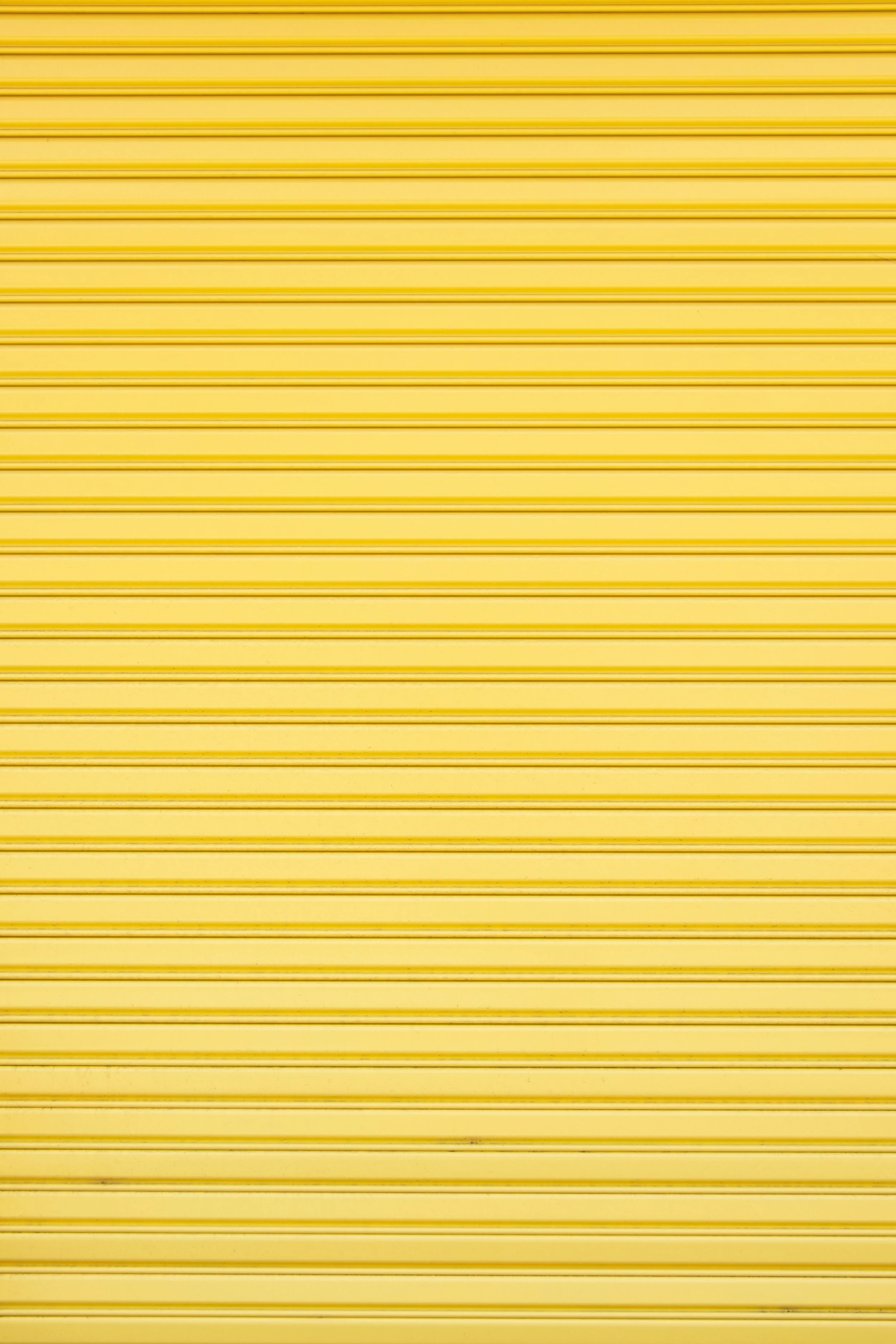 Yellow metal rolling shutter with horizontal ridges.
