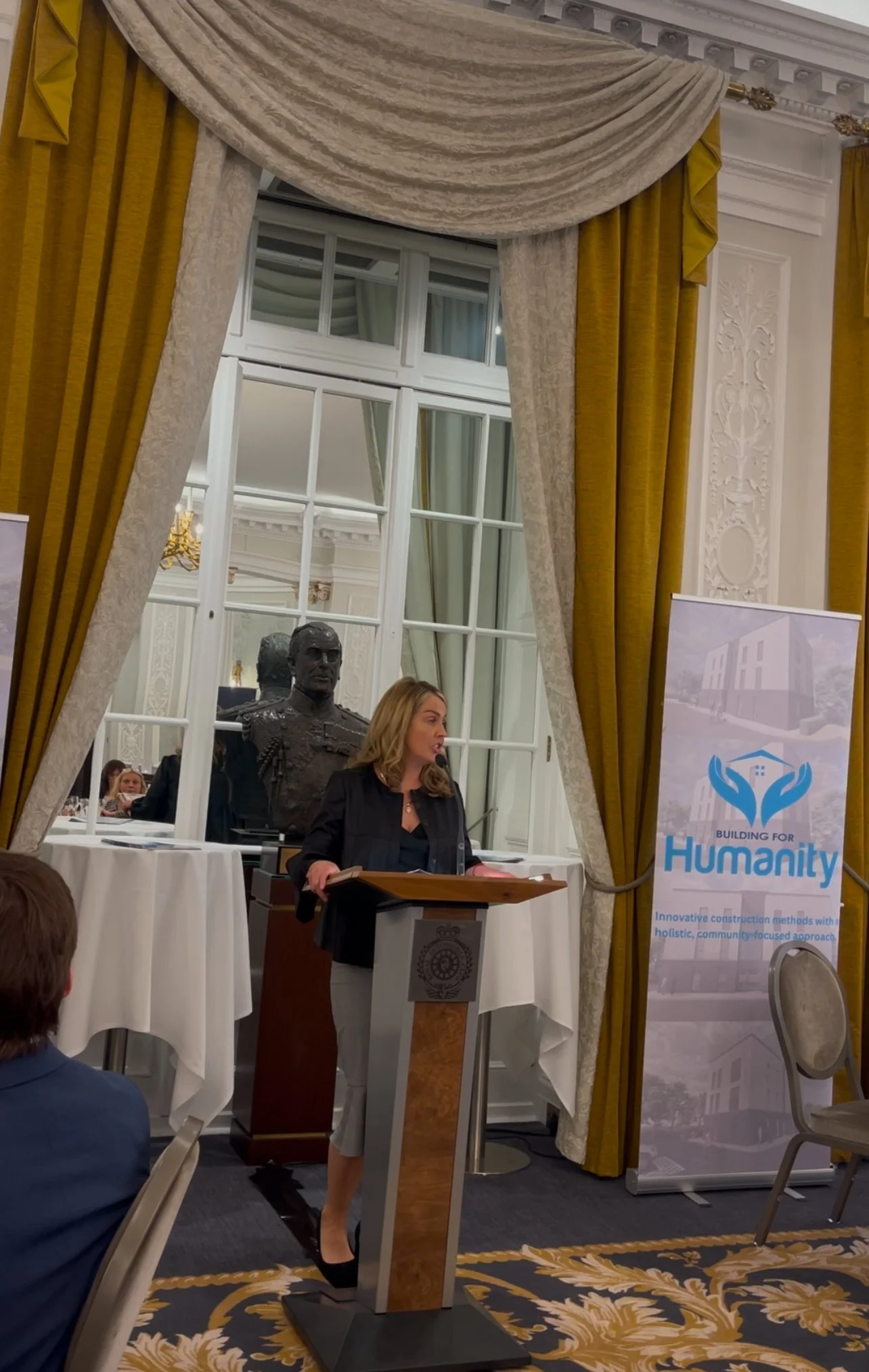 Louize Clark speaking at a Building for Humanity event, London