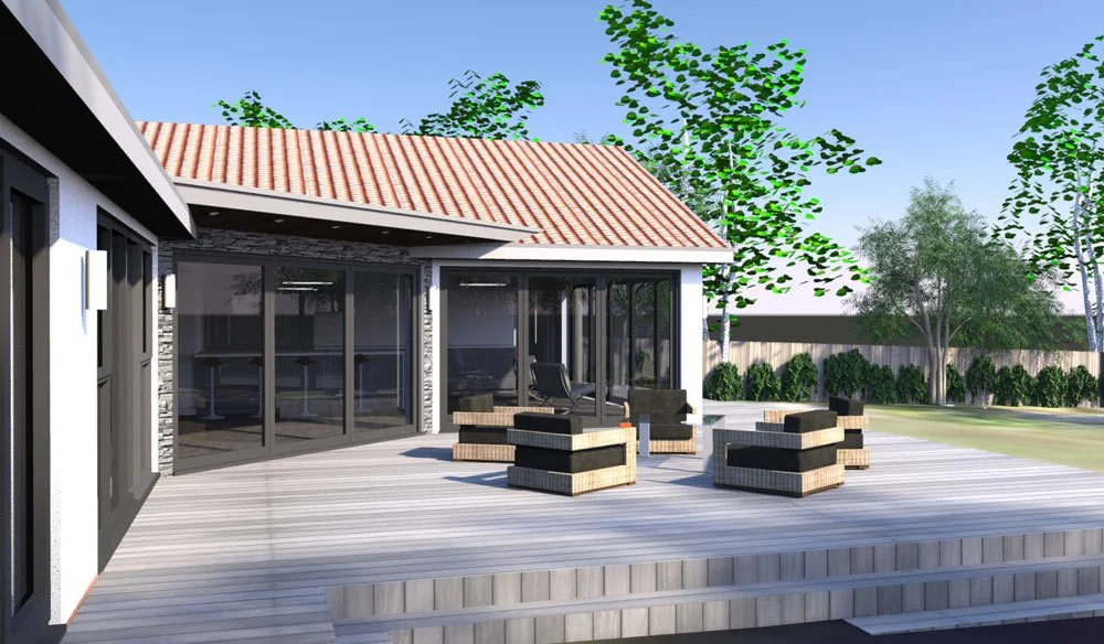 Backyard patio with outdoor furniture, house with glass doors, trees, and a lawn under a clear blue sky.