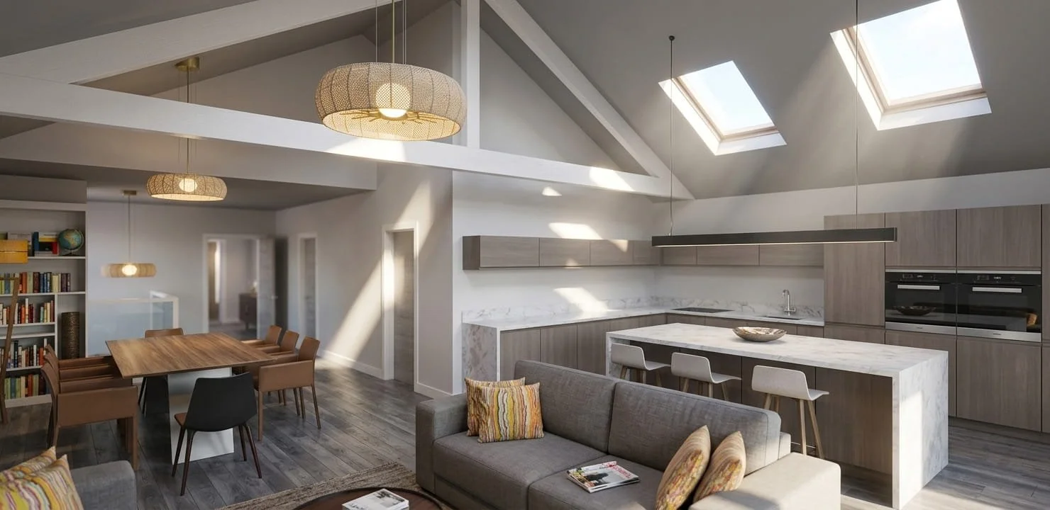 Interior of a modern open-plan living and kitchen space with a high vaulted ceiling, skylights, and wooden flooring. The kitchen features light wood cabinets and a marble island with bar stools. There's a gray sofa with colorful pillows, a wooden din
