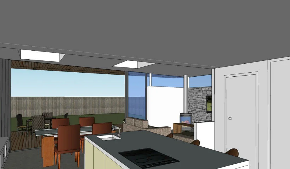 Interior view of a modern home with an open floor plan, featuring a kitchen with an island, a dining area with a wooden table and chairs, and a living room with a fireplace and large windows showing an outdoor patio with additional seating and a wood