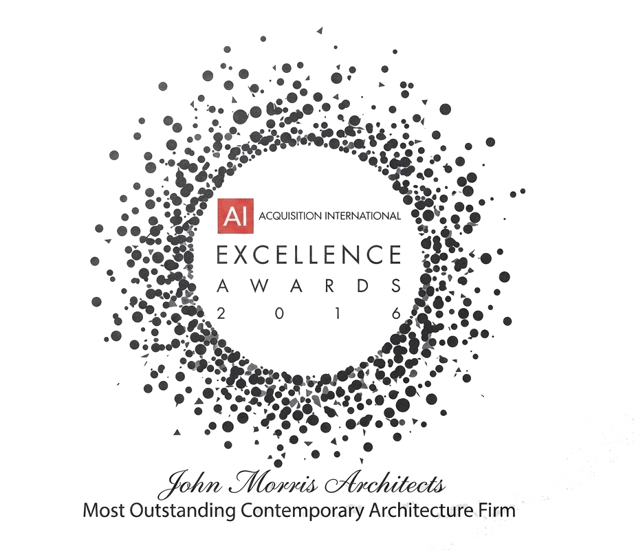 Black background with white and gray dots forming a circular pattern. Centered text reads: 'A I ACQUISITION INTERNATIONAL EXCELLENCE AWARDS 2016'. Below, it says: 'John-Morris Architects Most Outstanding Contemporary Architecture Firm'.