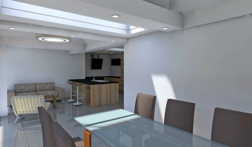 Modern dining area with a glass table, beige chairs, a sofa, a lounge chair, and a kitchen with an island and two wall-mounted TVs, in a brightly lit space with white walls and a ceiling skylight.