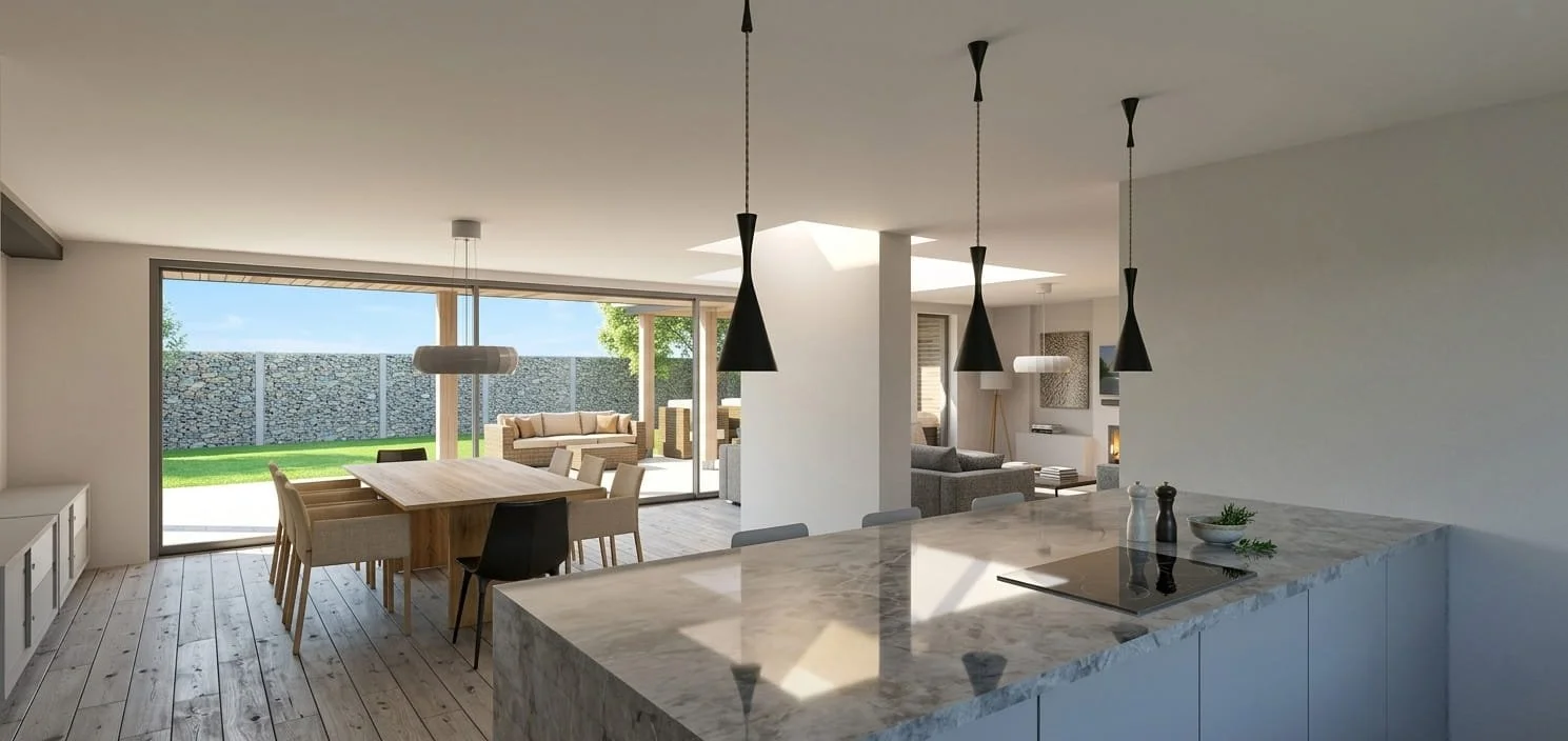 Open-concept kitchen and dining area with a marble island, pendant lights, a wooden dining table with chairs, and a living space with sofas and a fireplace, overlooking a backyard with grass and a stone wall.