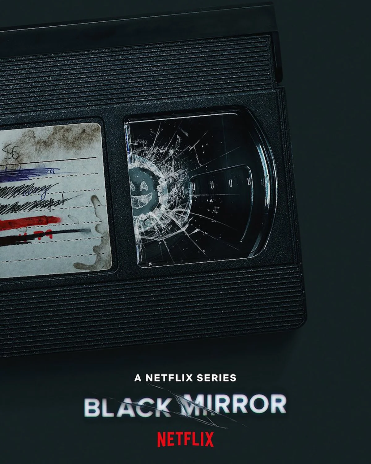 Poster for Netflix’s Black Mirror featuring a cracked VHS tape with distorted smiley face