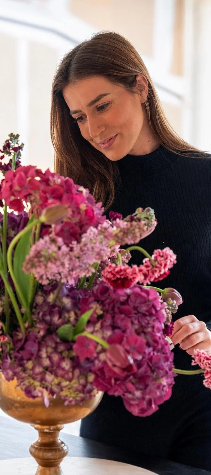 Floral director at Stemmed studio reviewing a bespoke seasonal arrangement for a London luxury wedding.