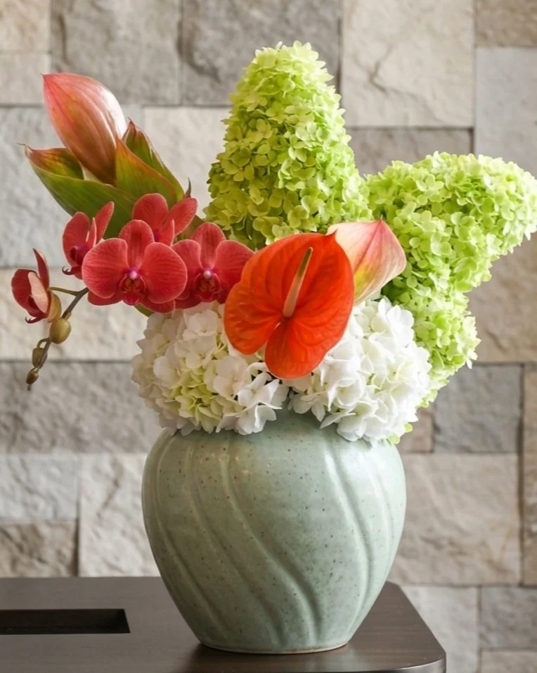 Our designs often explore the tension between the organic and the sculptural. By pairing lush seasonal hydrangeas with the sharp, architectural lines of premium orchids, we create bespoke arrangements that act as a focal point for editorial sets.