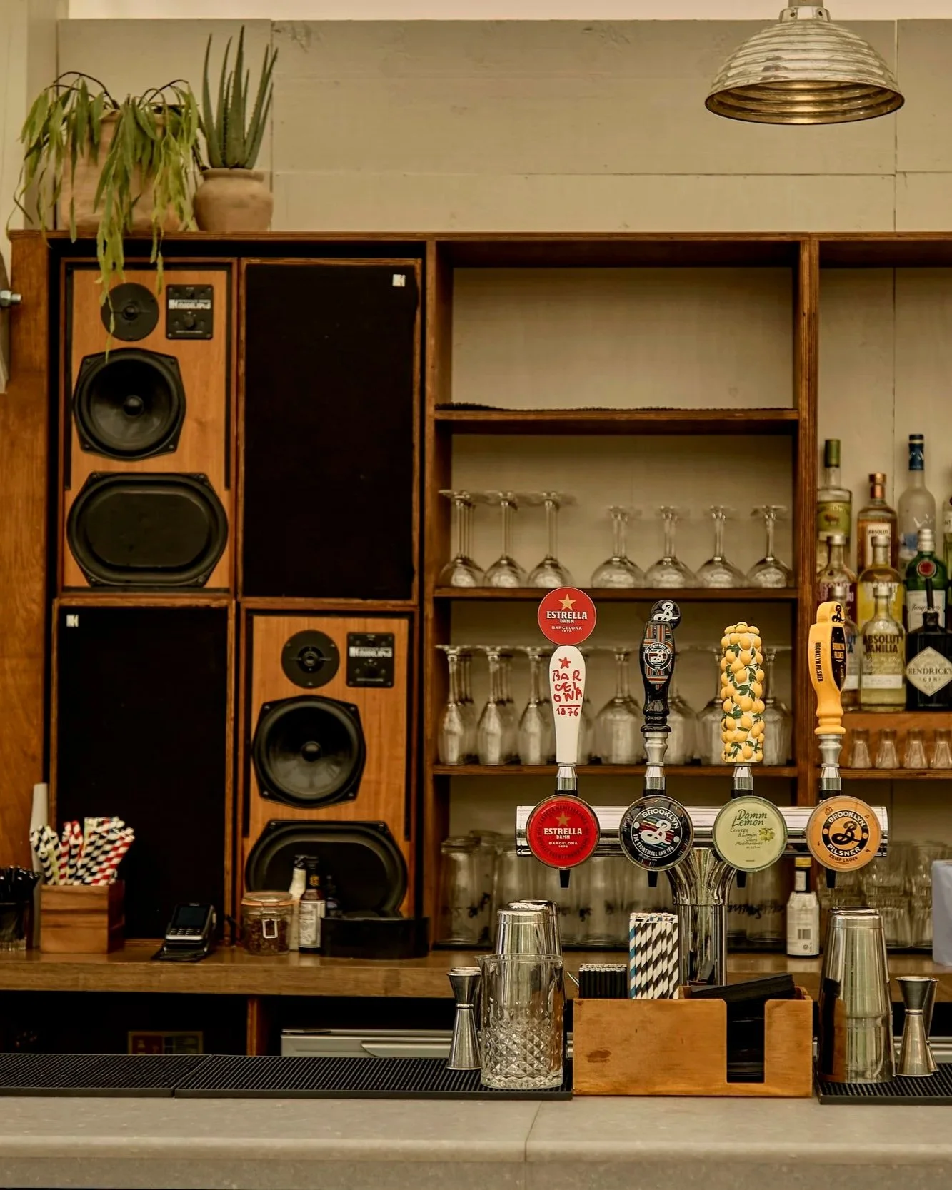 Interior lo-fi ply stained back bar festure within a semi-permanent structure situated on a london terrace smile plastics bar top