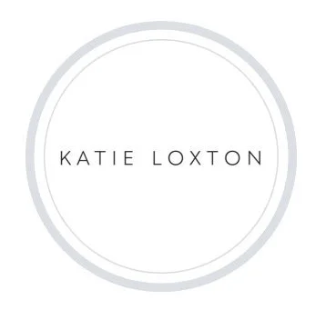 A white circular logo with a light gray border, featuring the text 'KATIE LOXTON' in the center.