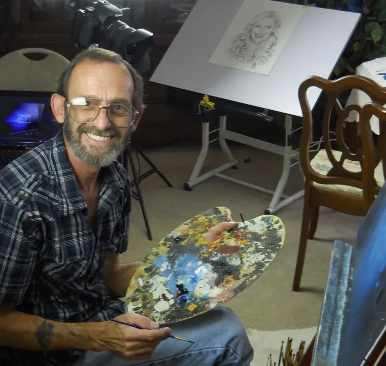 Picture of Murphy A Elliott sat at an artists easel smiling
