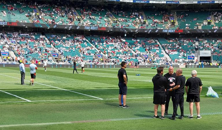 People on the pitch at a football stadium
