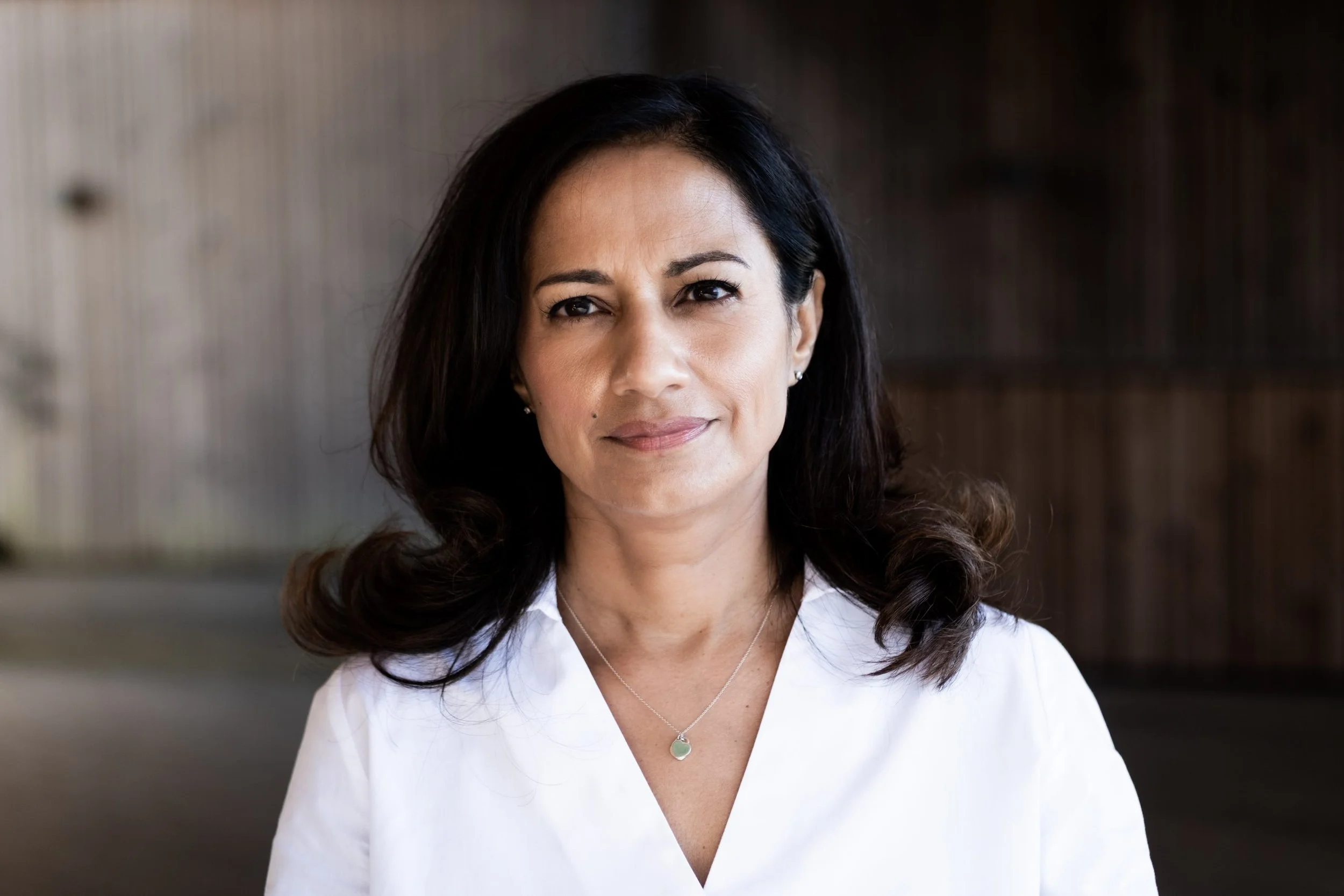 Portrait of Dr. Nashater Deu Solheim in a white blouse