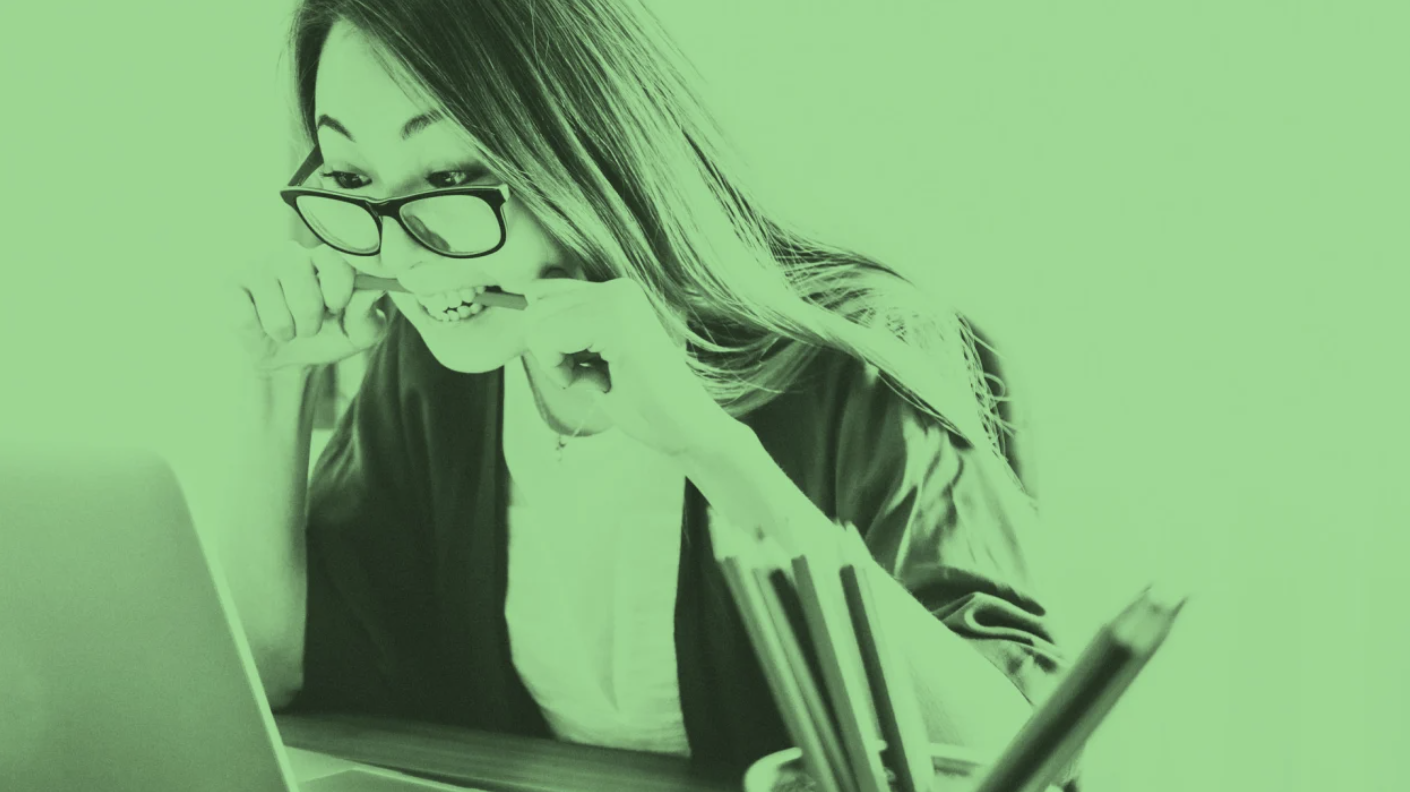 Woman with glasses seated at a laptop