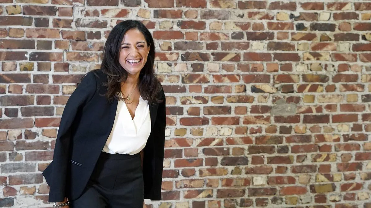 Dr. Nashater Deu Solheim smiling in a black suit