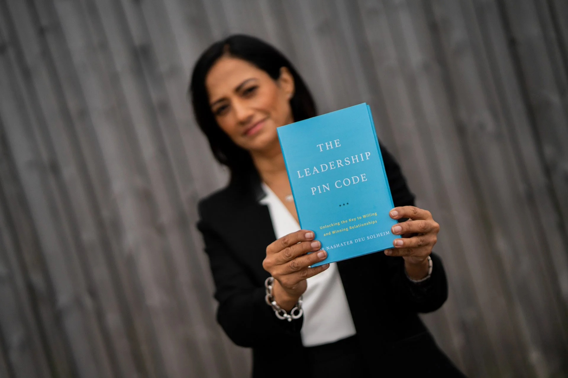 Dr. Nashater Deu Solheim holding The Leadership PIN Code