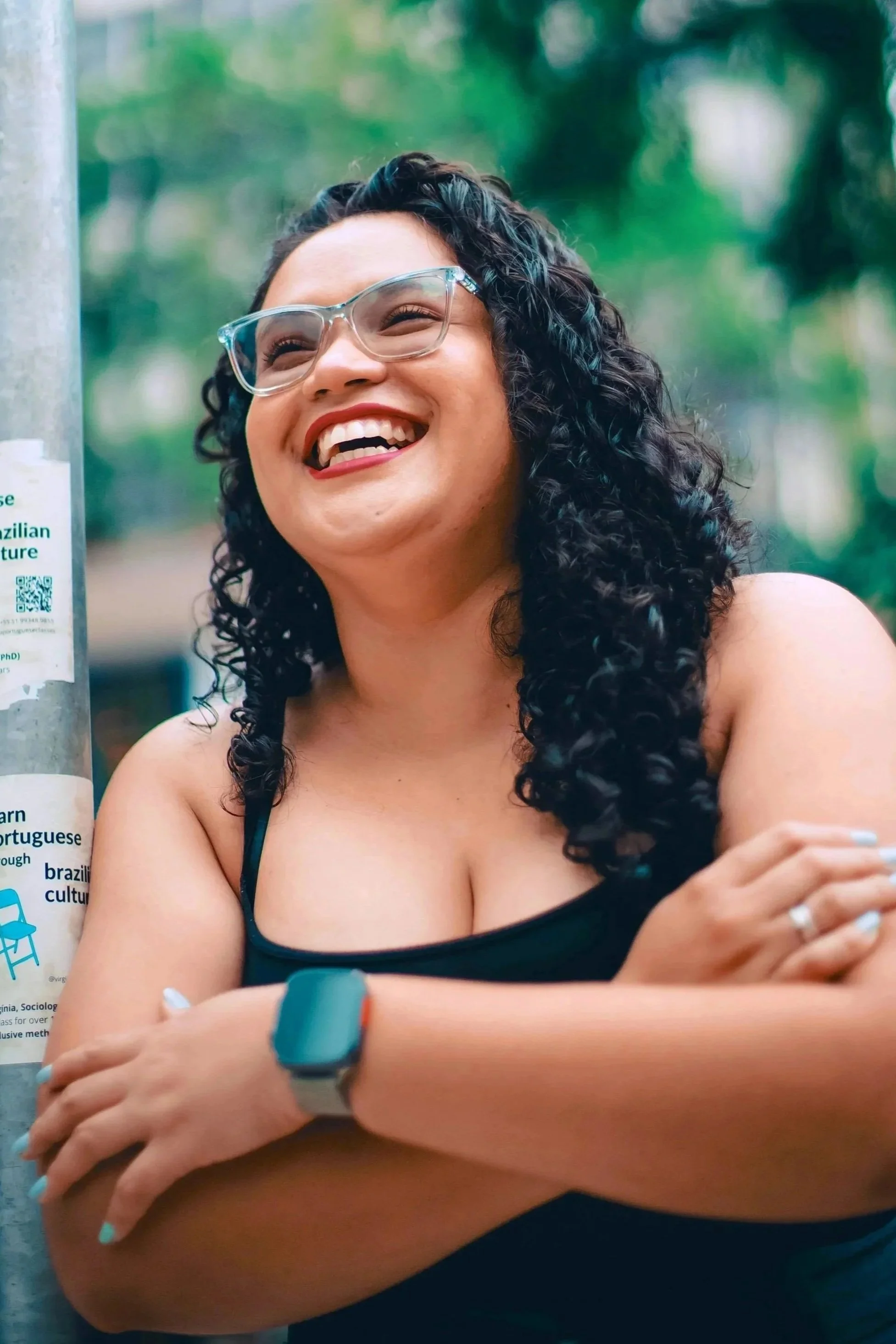 Photo of Brazillian woman with glasses, smiling and laughing
