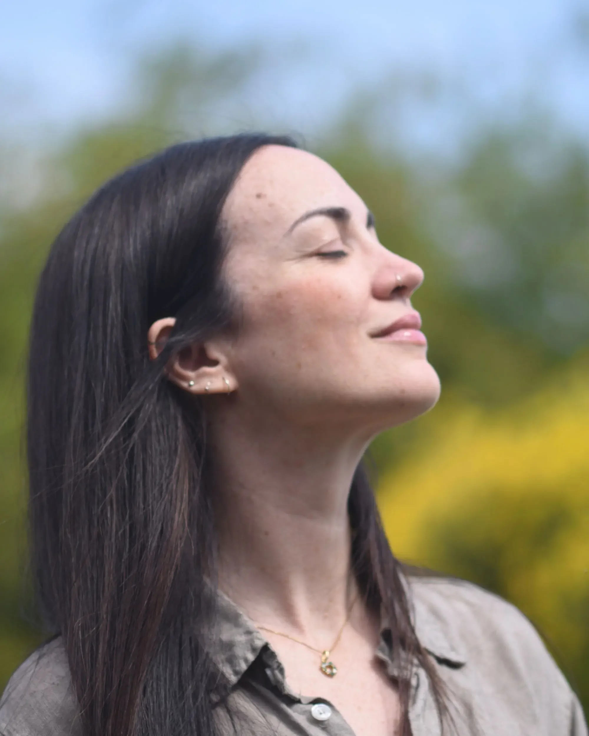 Profile view of artist Francesca V Kranz with closed eyes, capturing a sense of slow time, clarity, and psychological focus in nature.