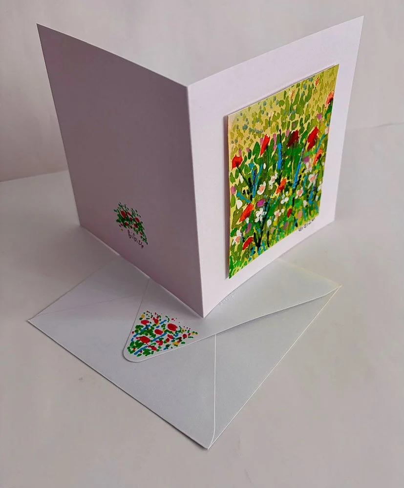 A pop-up greeting card with an outdoor garden scene on the front and an envelope with colorful confetti inside.