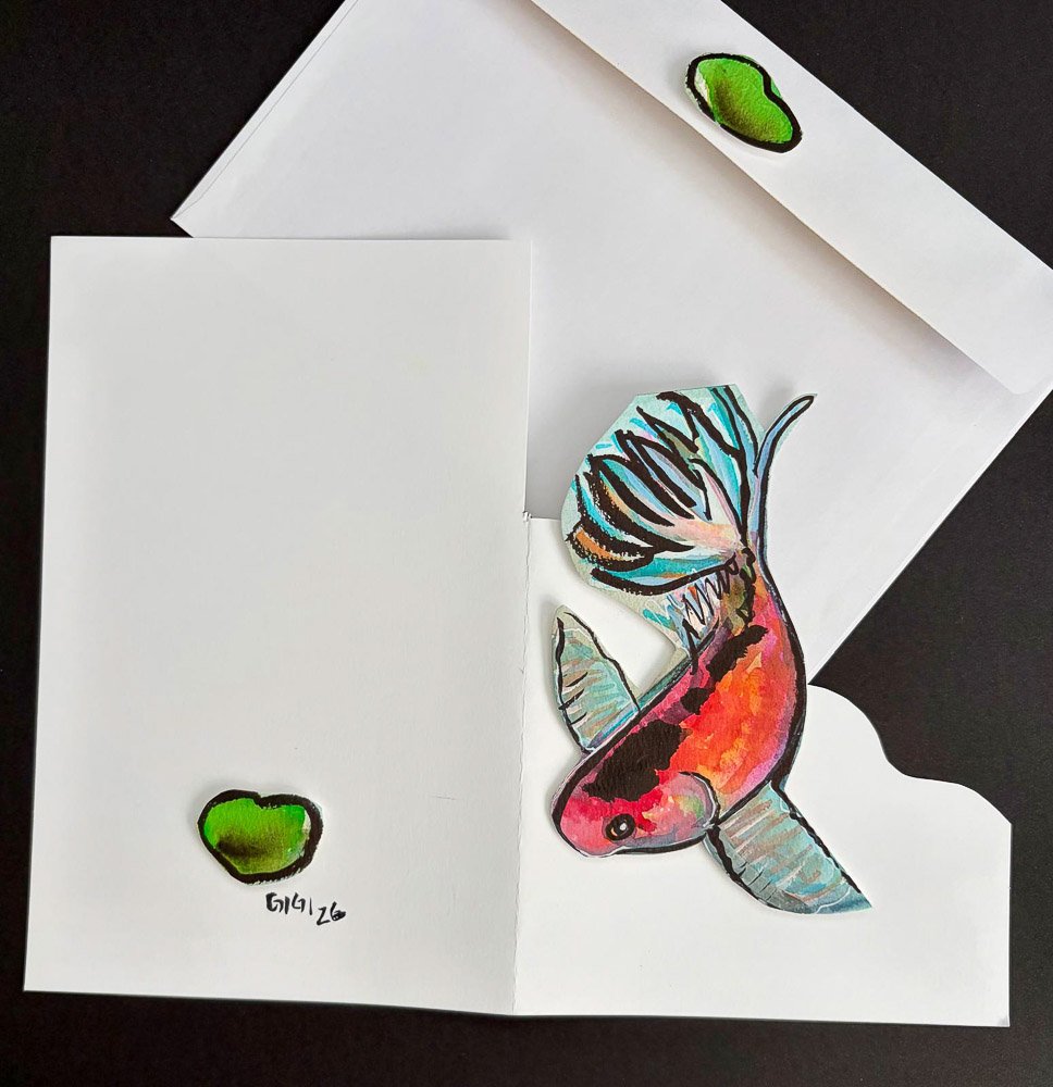 Colorful hand-drawn fish pop-up card with an envelope that has two green accents.
