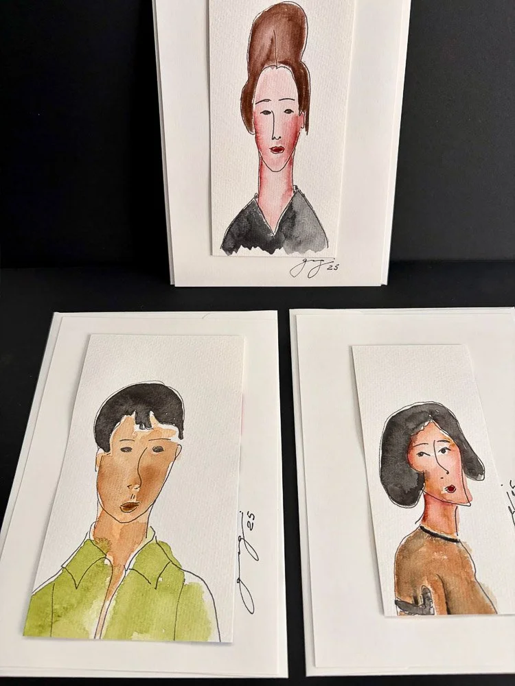Three watercolor portraits of women on white paper, with one standing upright and two lying flat, signed by the artist.