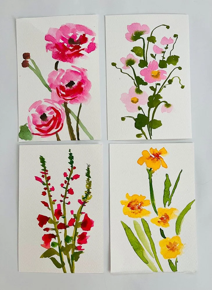 Set of four watercolor paintings of various flowers, each with different colors and types, on white paper.
