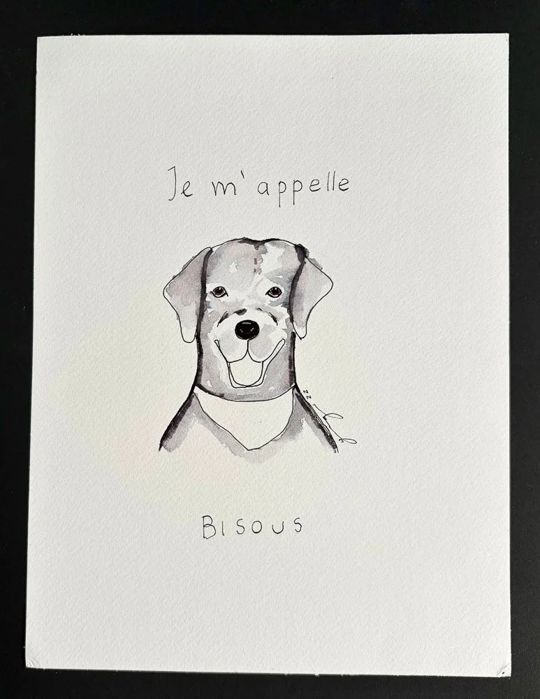 A hand-drawn illustration of a smiling dog with floppy ears, above French text that says "Je m'appelle Blous" on white paper.