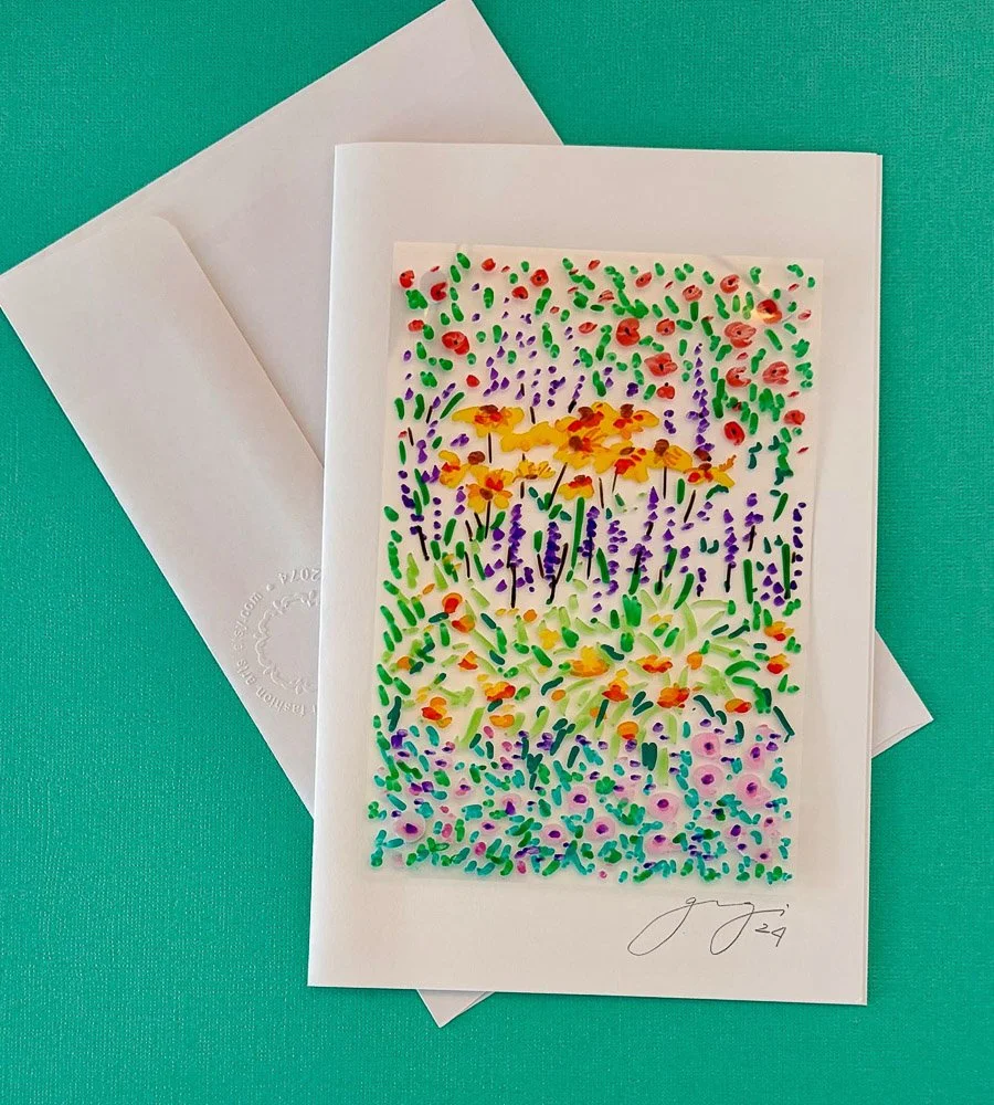 Colorful abstract watercolor painting of a garden scene with flowers and grass, signed at the bottom right.