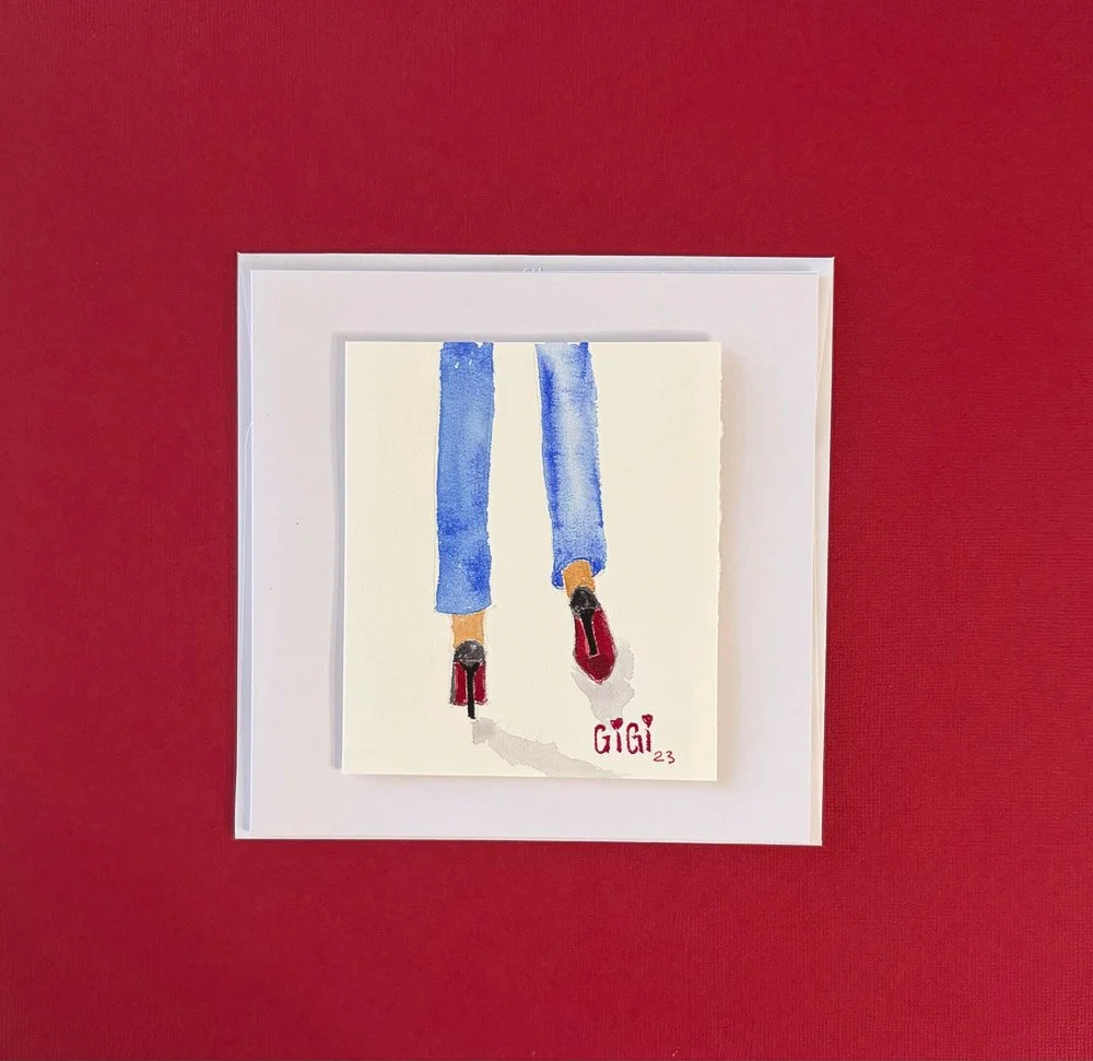Watercolor painting of a person wearing blue jeans and red shoes, signed 'GIGI' with hearts, on a white background, mounted on a red wall.