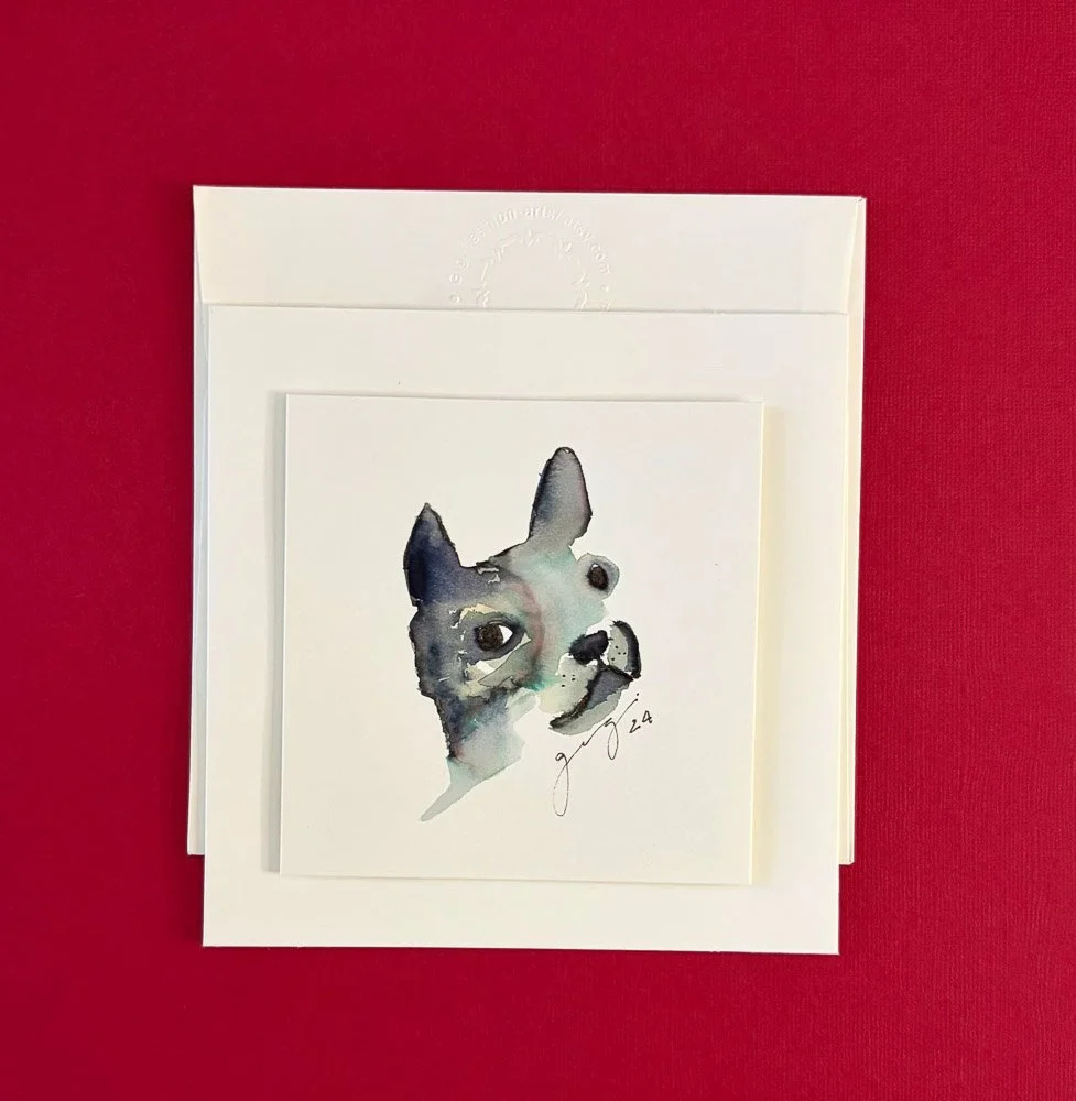 A set of greeting cards featuring a watercolor painting of a dog's face, signed by the artist, placed on a red background.