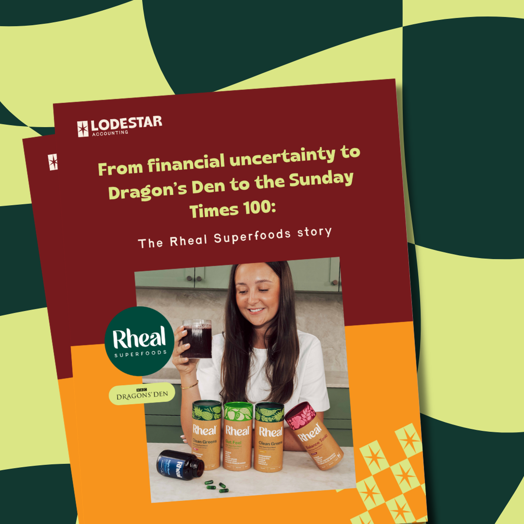 Book cover titled 'From financial uncertainty to Dragon's Den to the Sunday Times 100: The Rheal Superfoods story' showing a smiling woman holding a glass of dark juice, with several cans of Rheal Superfoods products and capsules on the counter in front of her.