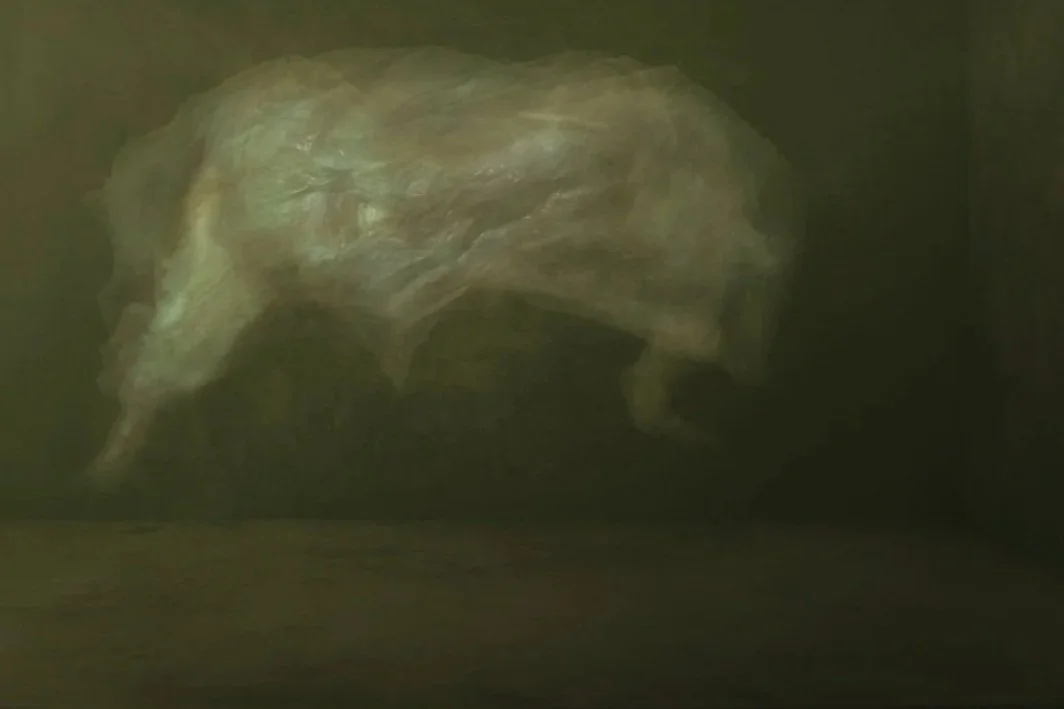 A blurred, abstract image of what appears to be a large animal, possibly a mammoth or an elephant, with a greenish background.