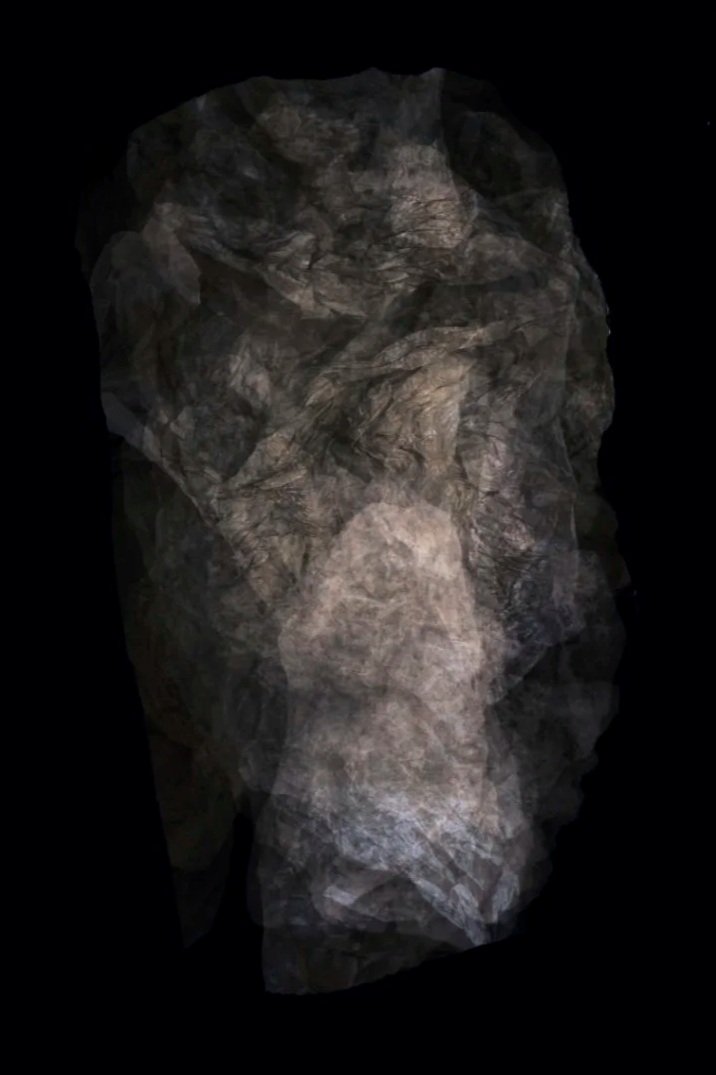 A crumpled sheet of brown and gray tissue paper on a black background.