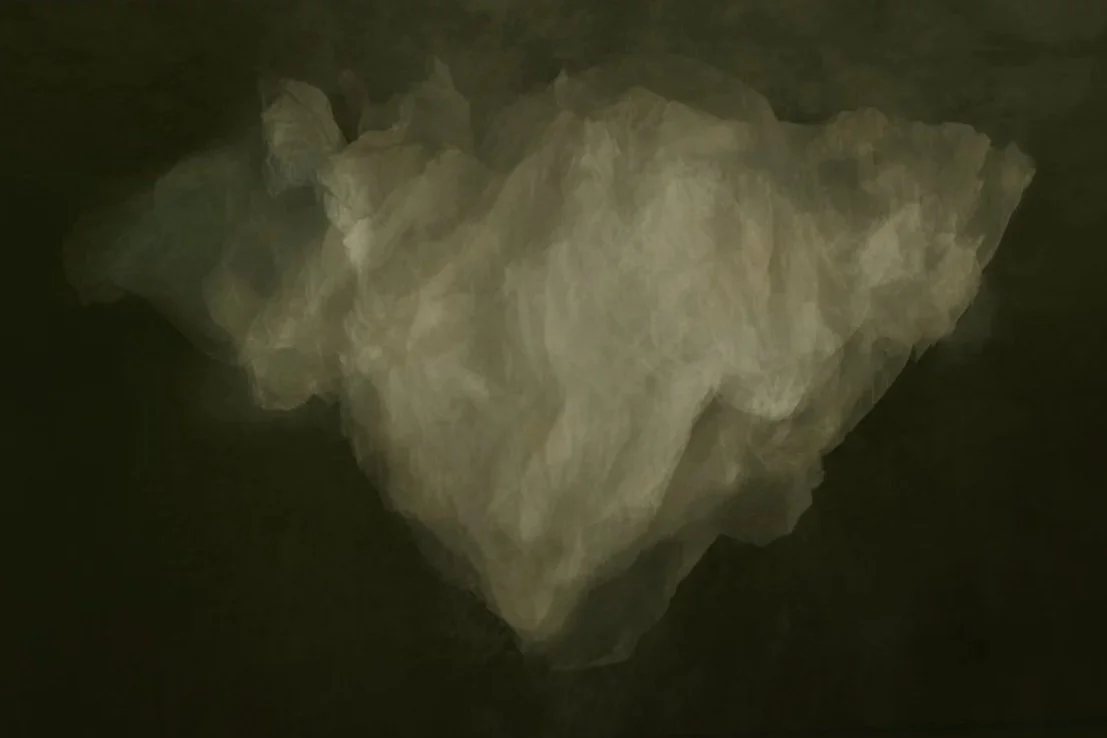 A crumpled piece of translucent white tissue paper on a dark surface.