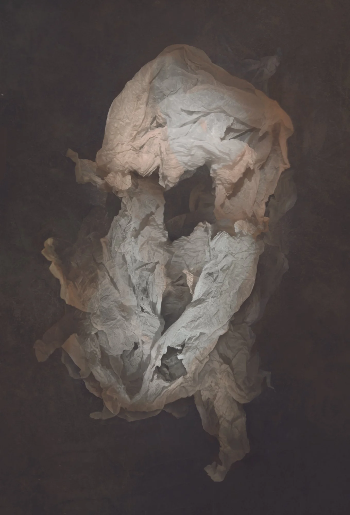 Crumpled pieces of white tissue paper on a dark surface.