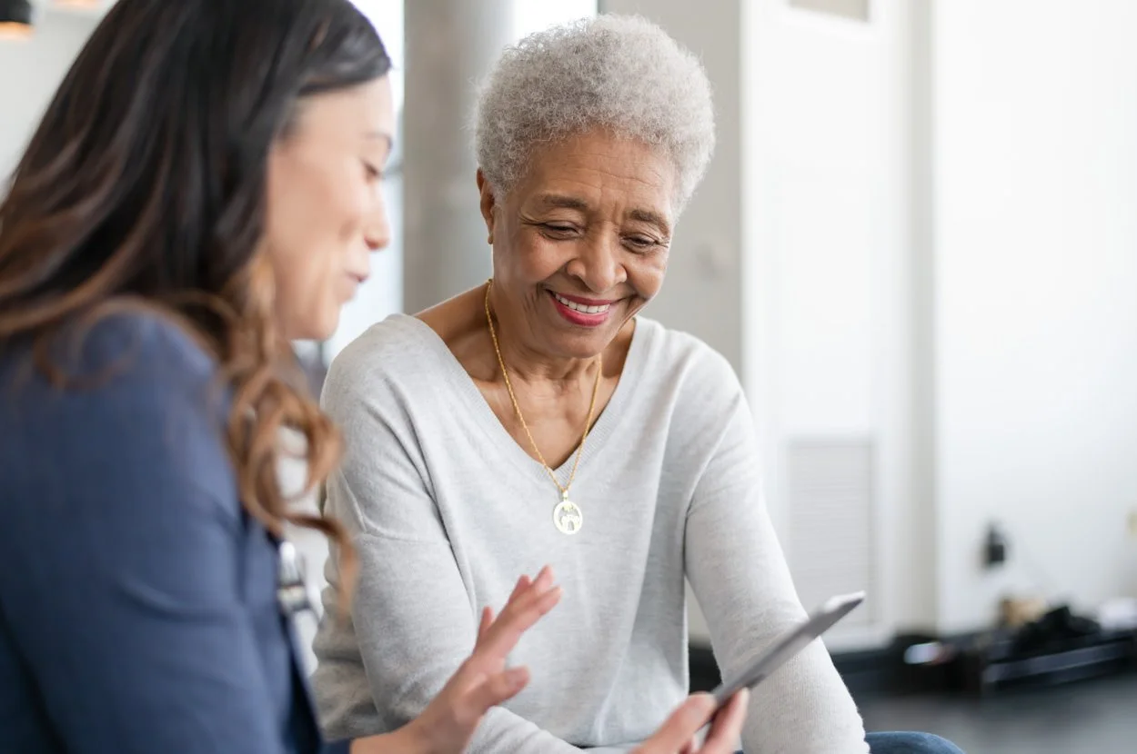 Doctor supporting older female patient