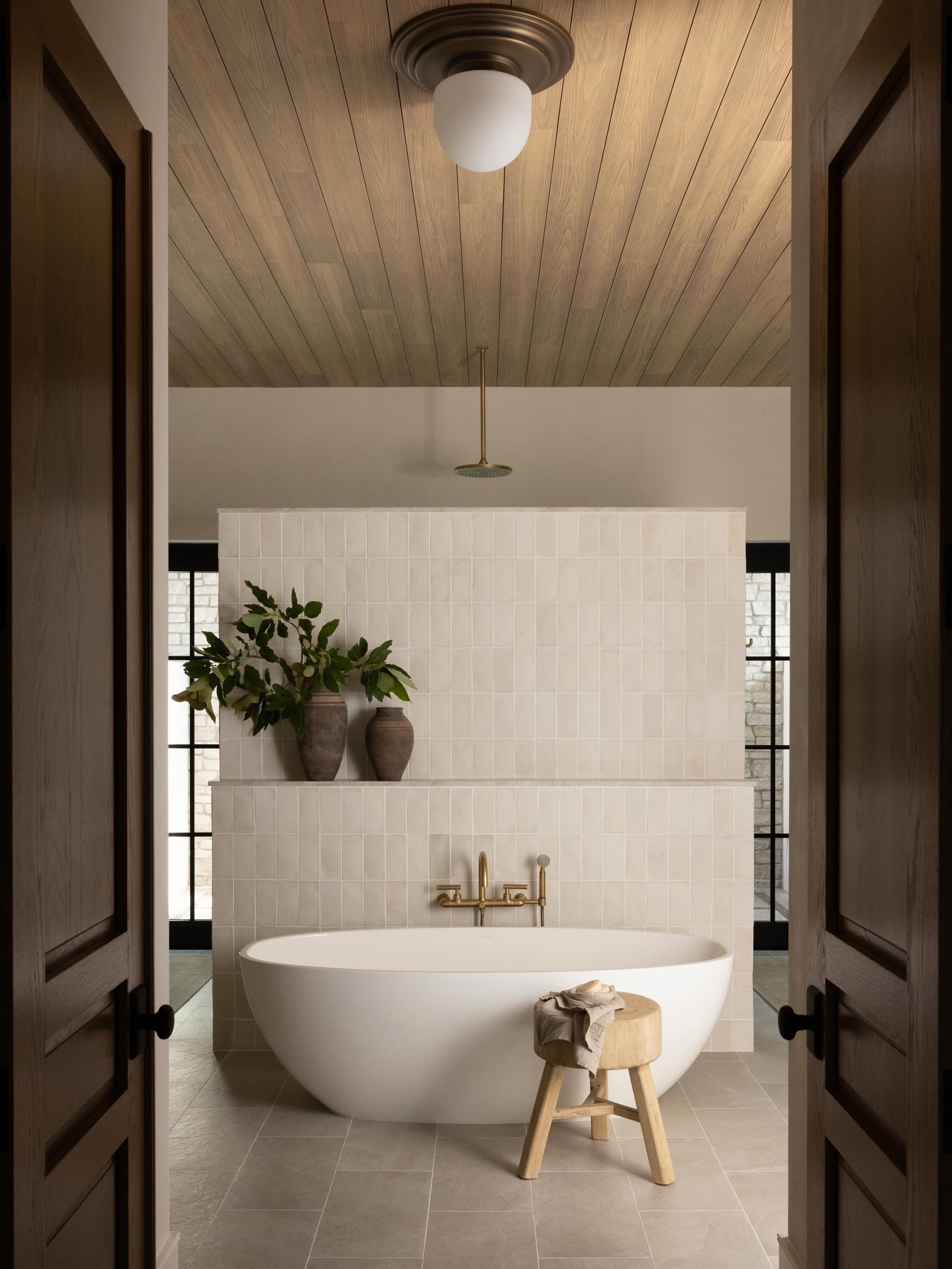 One of our favorite bathroom layouts to date. 

A stained wood ceiling, textured tile, mixed stone finishes, and a wall of glass that opens to the outdoor wellness area designed to bring a little calm to the everyday. 

Design @ashleymartinhome 
Phot