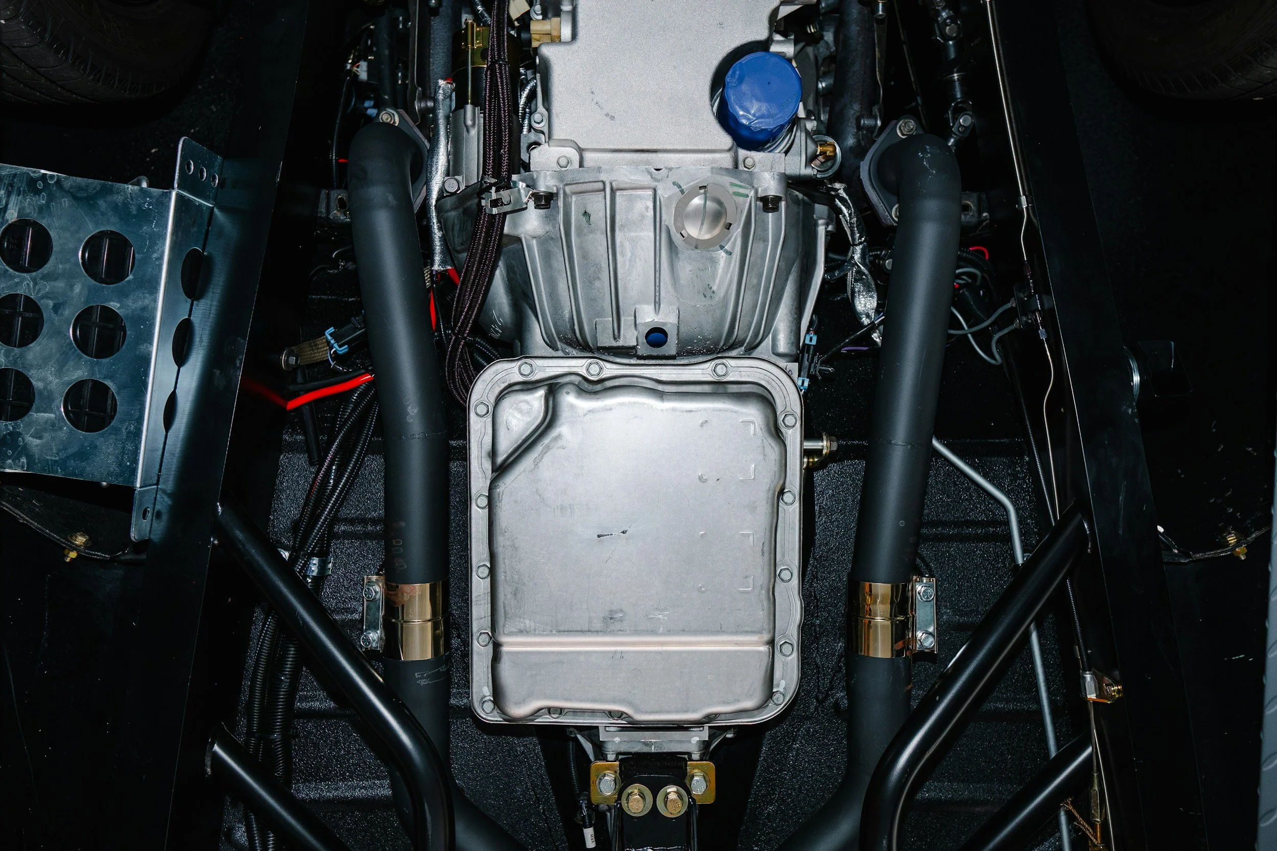Service on a car engine and transmission system, suspension components and wiring.