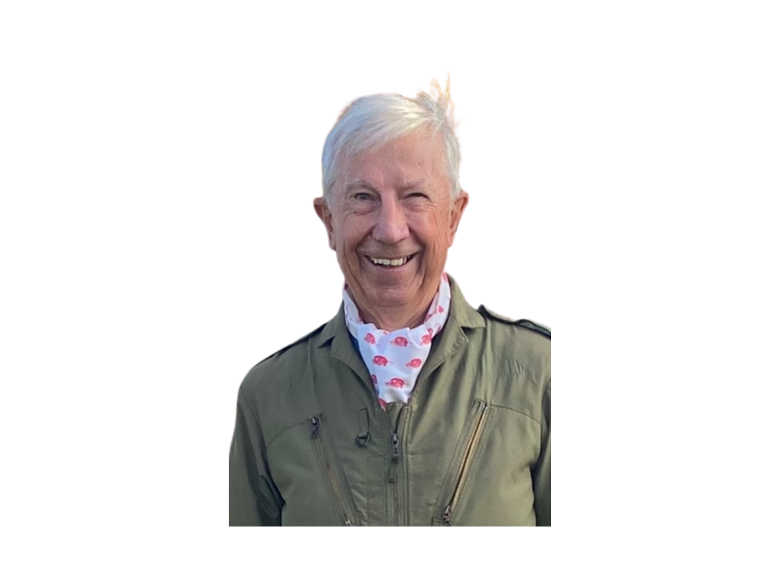 A smiling elderly man with white hair, wearing a green jacket with a zippered front and a white scarf with red parrot patterns.