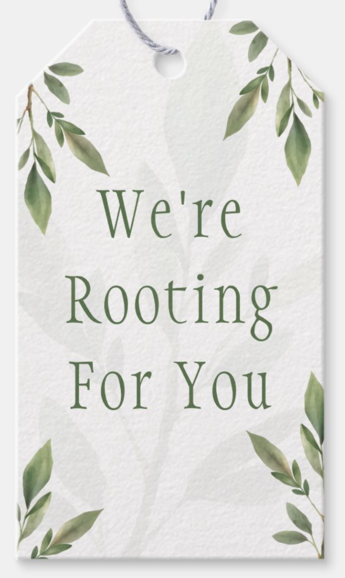A white gift tag with green leafy decorations and the text "We're Rooting For You" in green font.