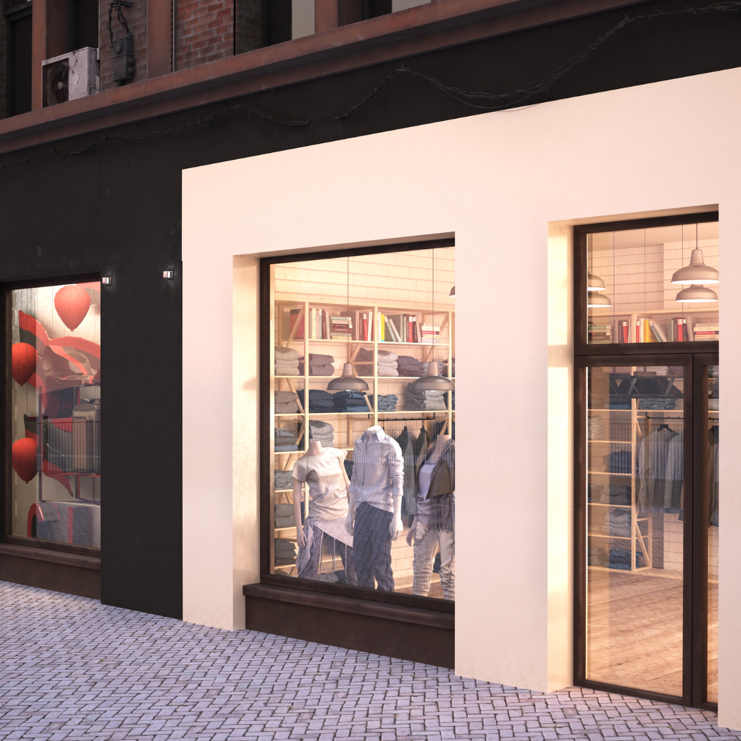 Store window display with mannequins dressed in casual clothes, wooden shelves with folded clothes, books, and hanging lamps inside.