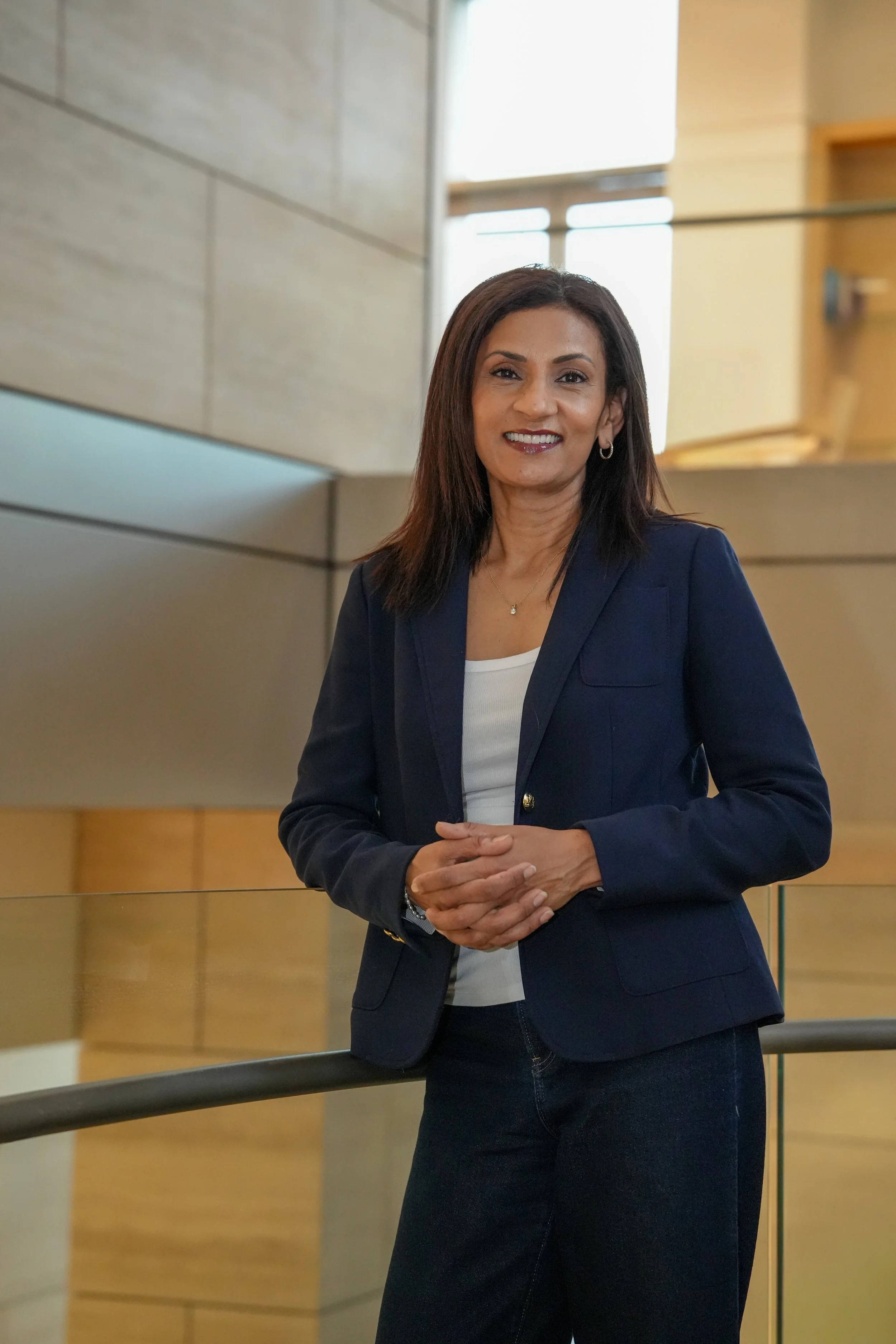 Poornima professional headshot - modern office.